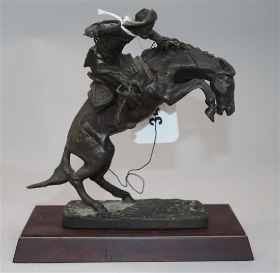 A Franklin Mint bronzed figure, The Broncho Buster, after Frederic Remington 17cm.